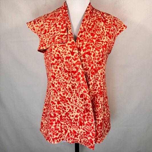 A red and beige leopard print wrap-style blouse displayed on a white mannequin torso against a light gray fabric backdrop.
