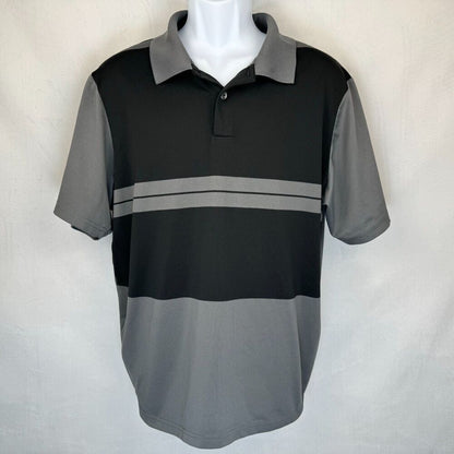 A men's short-sleeve polo shirt in black and gray color blocking, displayed on a white mannequin torso against a light gray fabric backdrop.