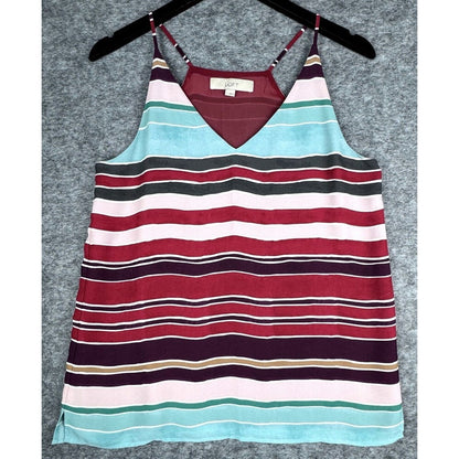 A striped camisole tank top with thin straps, hanging on a black hanger against a textured gray background. The top features horizontal stripes in red, light blue, white, dark gray, and deep purple.