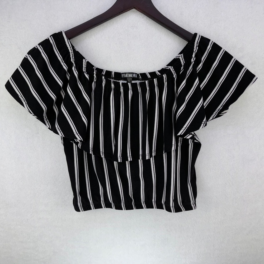 A black and white vertically striped short-sleeve crop top with a square neckline, hanging on a dark wooden hanger against a white textured background.
