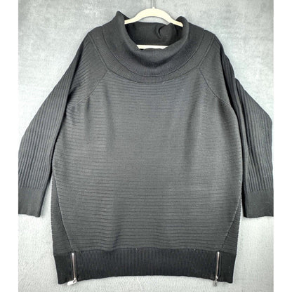 A dark gray ribbed knit sweater with a mock neck, raglan sleeves, and silver zipper details at the hem, hanging on a white hanger against a textured gray background.