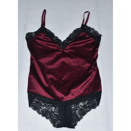 A burgundy satin lingerie bodysuit with black lace trim on the cups, underwire, and leg openings, displayed flat against a light gray background.