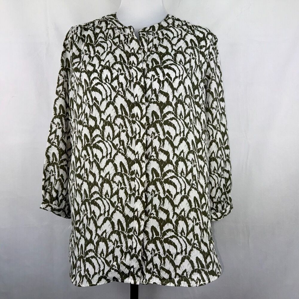 A women's long-sleeve blouse with a textured, raised abstract pattern in olive green and off-white, displayed on a mannequin torso against a light gray background.