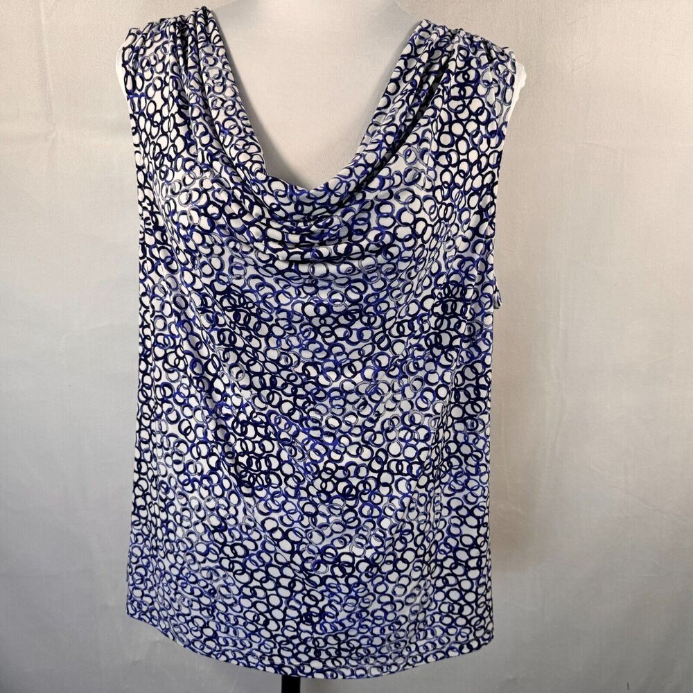 A sleeveless cowl-neck top with an abstract blue, black, and white spotted pattern, displayed on a white dress form against a light gray fabric backdrop.