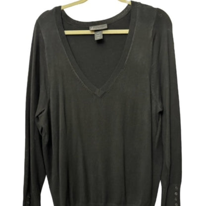 A dark charcoal gray long-sleeve V-neck knit top hanging on a light wood hanger against a white background.