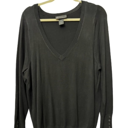 A dark charcoal gray long-sleeve V-neck knit top hanging on a light wood hanger against a white background.