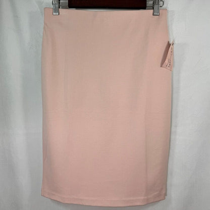 A light pink pencil skirt hanging from a dark hanger against a white fabric backdrop. A small fabric tag is visible on the right side.