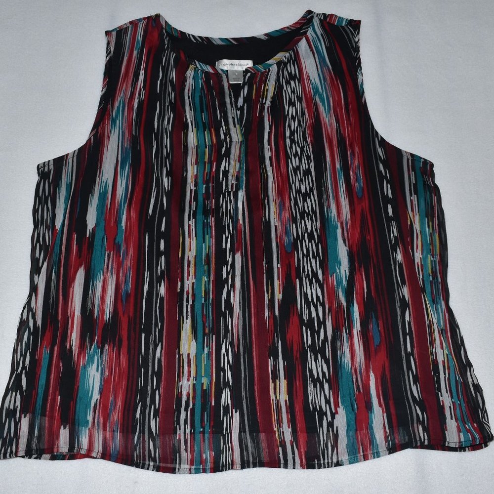 A sleeveless top with a vibrant vertical ikat-style stripe pattern in red, teal, black, white, and beige, laid flat on a light gray background.