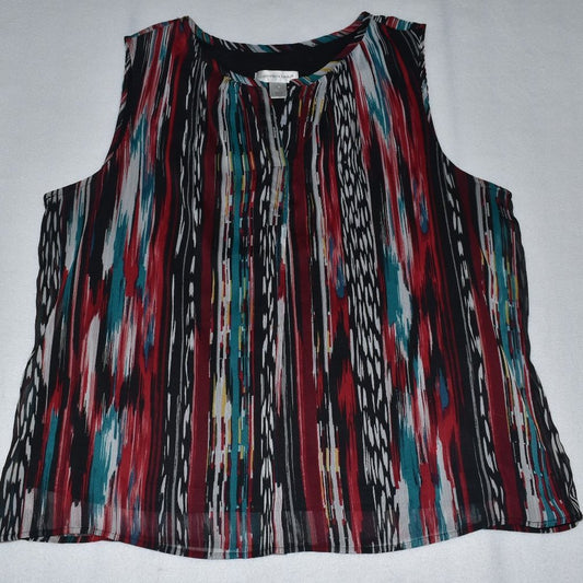 A sleeveless top with a vibrant vertical ikat-style stripe pattern in red, teal, black, white, and beige, laid flat on a light gray background.