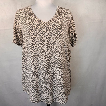 A short-sleeve V-neck top with an all-over leopard print pattern, displayed on a mannequin torso against a light gray fabric backdrop.