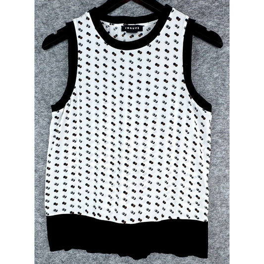 A sleeveless white knit top with a black dotted pattern, black trim, and a black ruffled hem, hanging on a black hanger against a gray textured background.