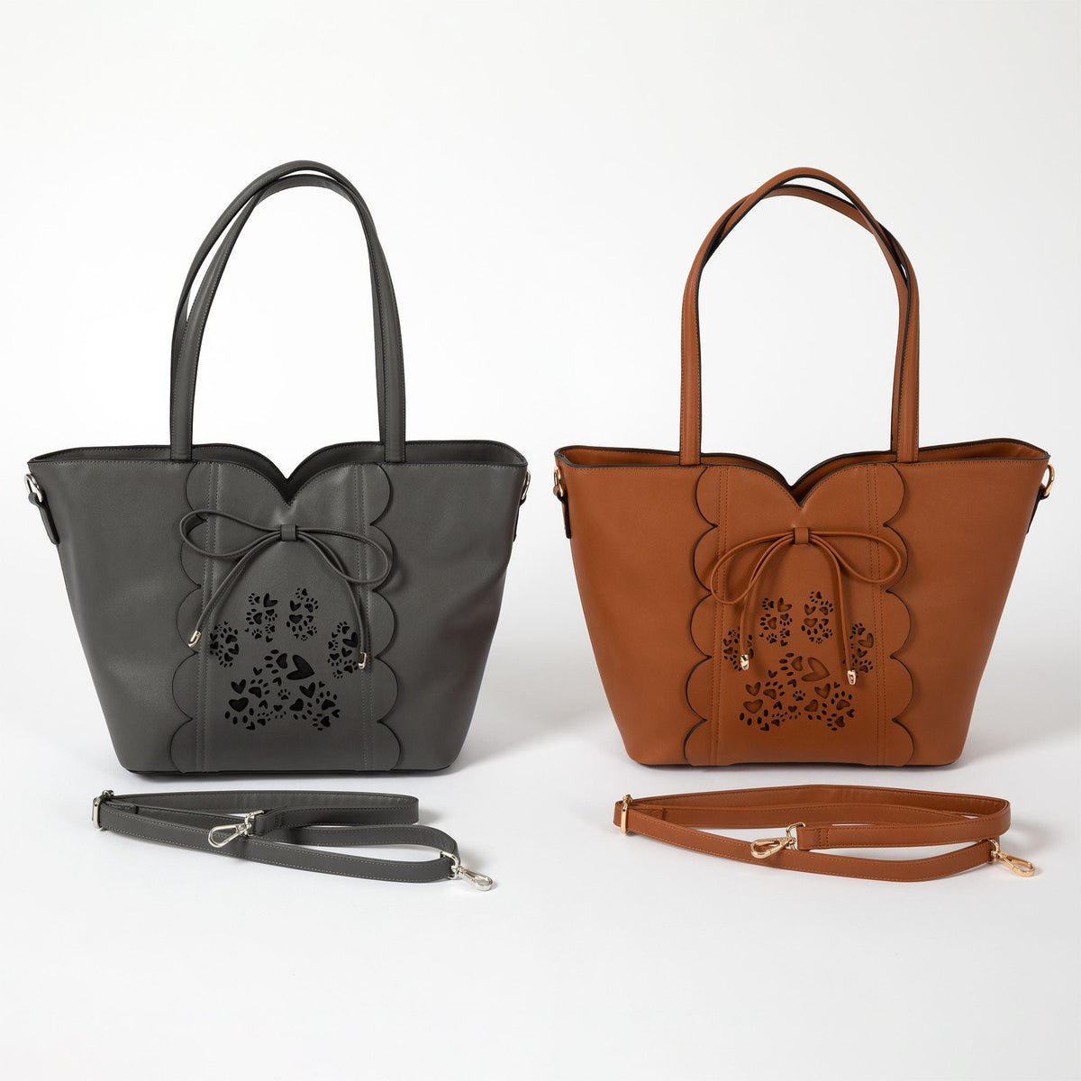 GreaterGood Bow & Hearts Paw Print faux leather handbags in gray and camel, featuring decorative bows, laser-cut paw print designs, top handles and adjustable straps.