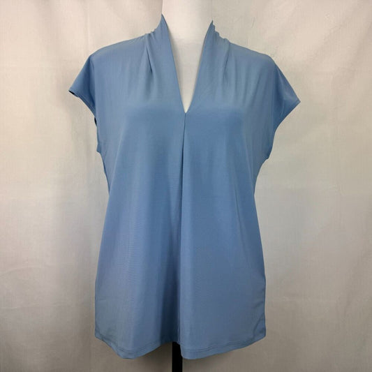 A light blue short-sleeve blouse with a split V-neckline, displayed on a mannequin torso against a light gray fabric backdrop.