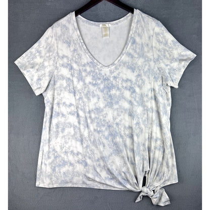 A women's short-sleeve V-neck tie-dye top in white and light blue, featuring a front knot detail at the hem, displayed on a hanger against a gray textured background.