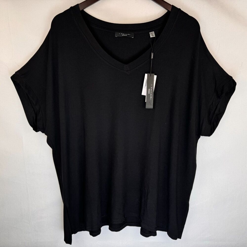 A black short-sleeve V-neck top hanging on a wooden hanger against a white background, with a hangtag attached.