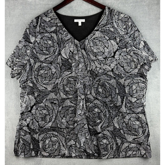 A short-sleeve V-neck blouse with an all-over black and gray abstract line pattern, hanging on a dark wooden hanger against a textured gray background.