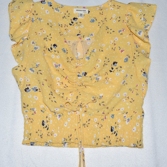 A yellow floral crop top with ruffled cap sleeves, a gathered front, and a drawstring tie at the waist, laid flat on a white background.