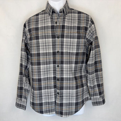 A long-sleeve button-down plaid shirt in black, gray, and white with thin tan stripes, displayed on a white mannequin torso against a light off-white background.