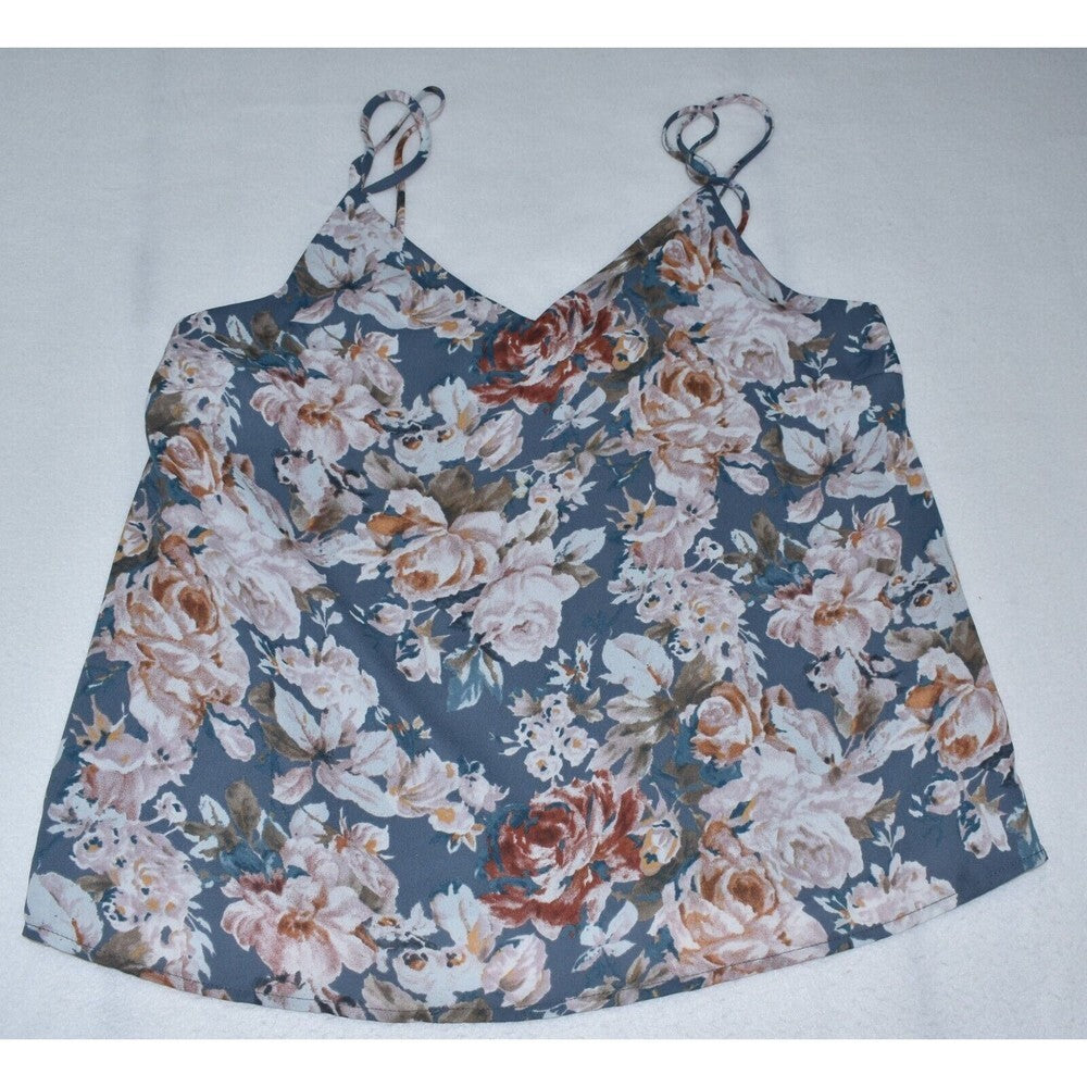 A sleeveless floral camisole top with thin shoulder straps, featuring a dense rose and floral print in dusty blue, beige, white, and rust orange tones, laid flat on a light gray background.
