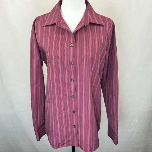 A long-sleeve button-up shirt with vertical pink and purple stripes, displayed on a white mannequin torso against a light gray fabric backdrop.