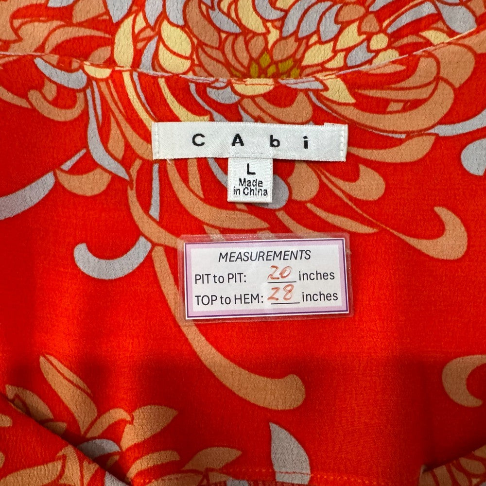 Clothing tag view of red floral patterned fabric with Cabi label and measurements 