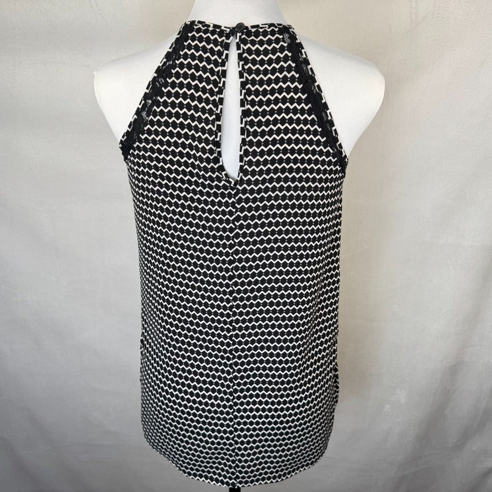 Back view of Candies Black and white patterned sleeveless top on a mannequin against a plain background