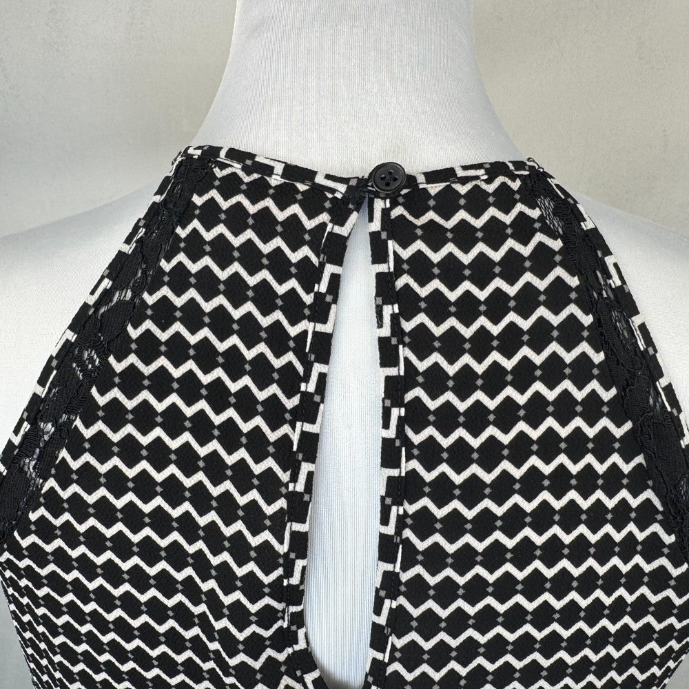 Back top detail on Candies Black and white patterned garment on a mannequin with a plain background