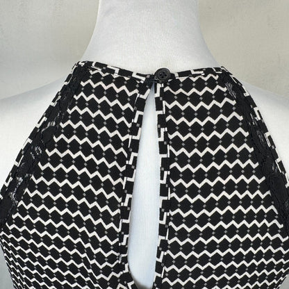 Back top detail on Candies Black and white patterned garment on a mannequin with a plain background