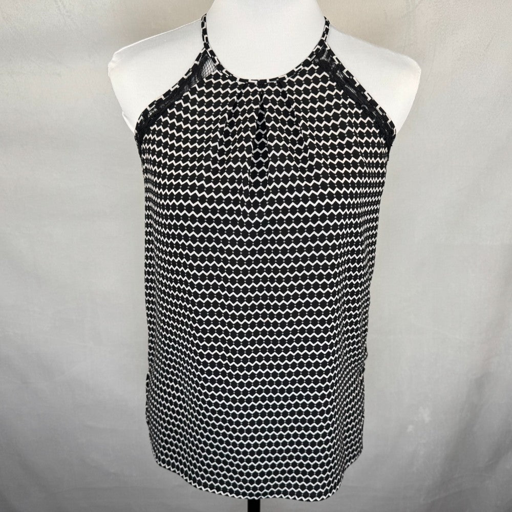 Front view of Candies Black and white patterned top on a mannequin against a gray background