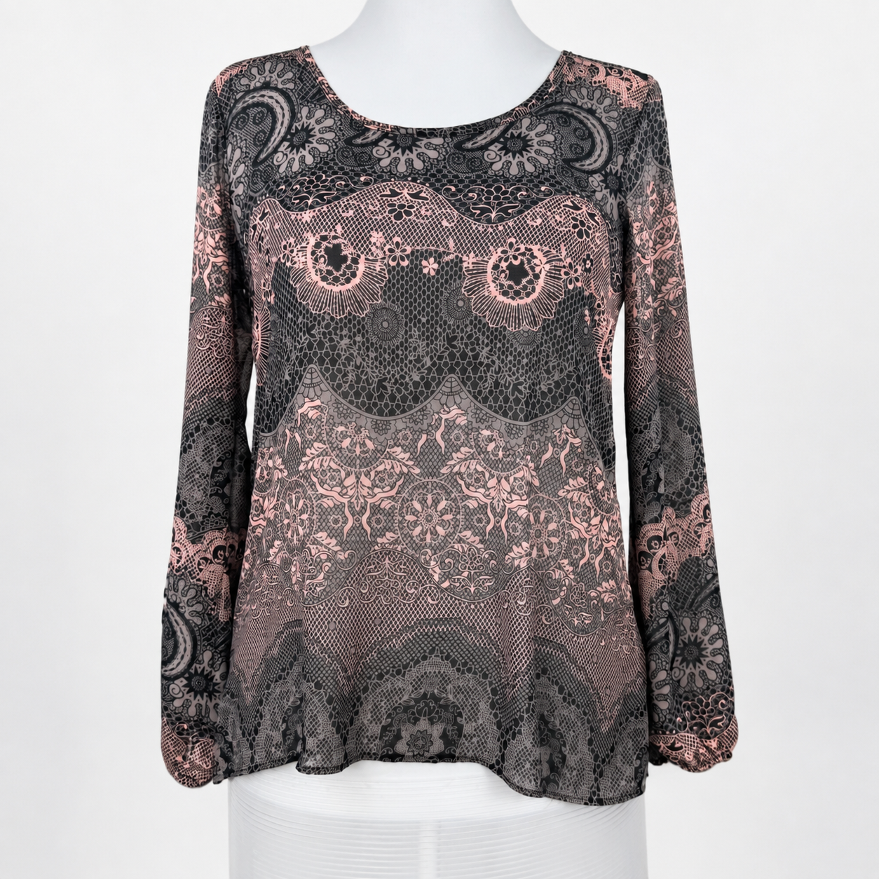 A long-sleeve lace top displayed on a white mannequin torso against a plain white background. The top features an intricate floral and paisley lace pattern in black and dusty rose pink.