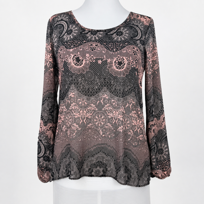 A long-sleeve lace top displayed on a white mannequin torso against a plain white background. The top features an intricate floral and paisley lace pattern in black and dusty rose pink.