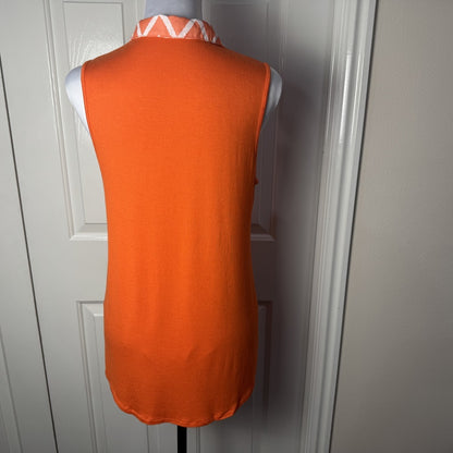 Back view on Femme by Tresics orange blouse  on a mannequin against a white wall