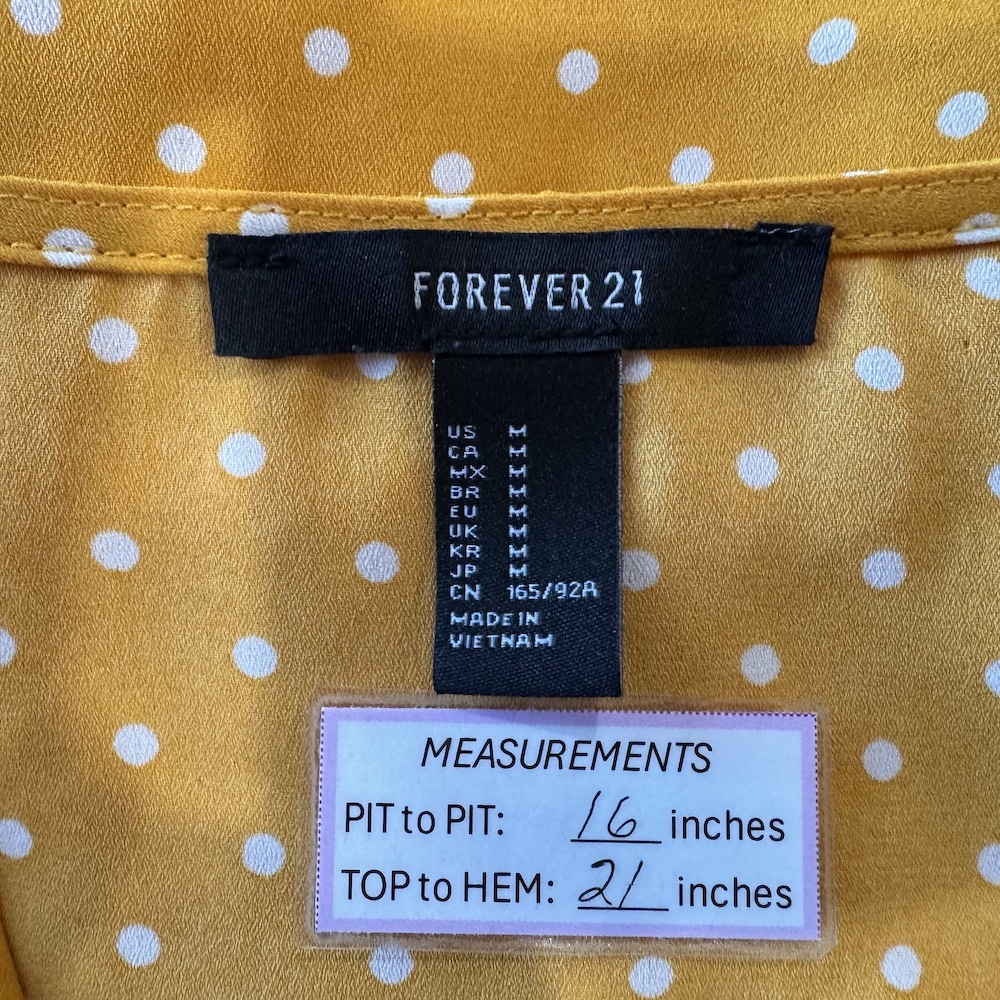 Clothing tag on Forever 21 women's blouse yellow, size M