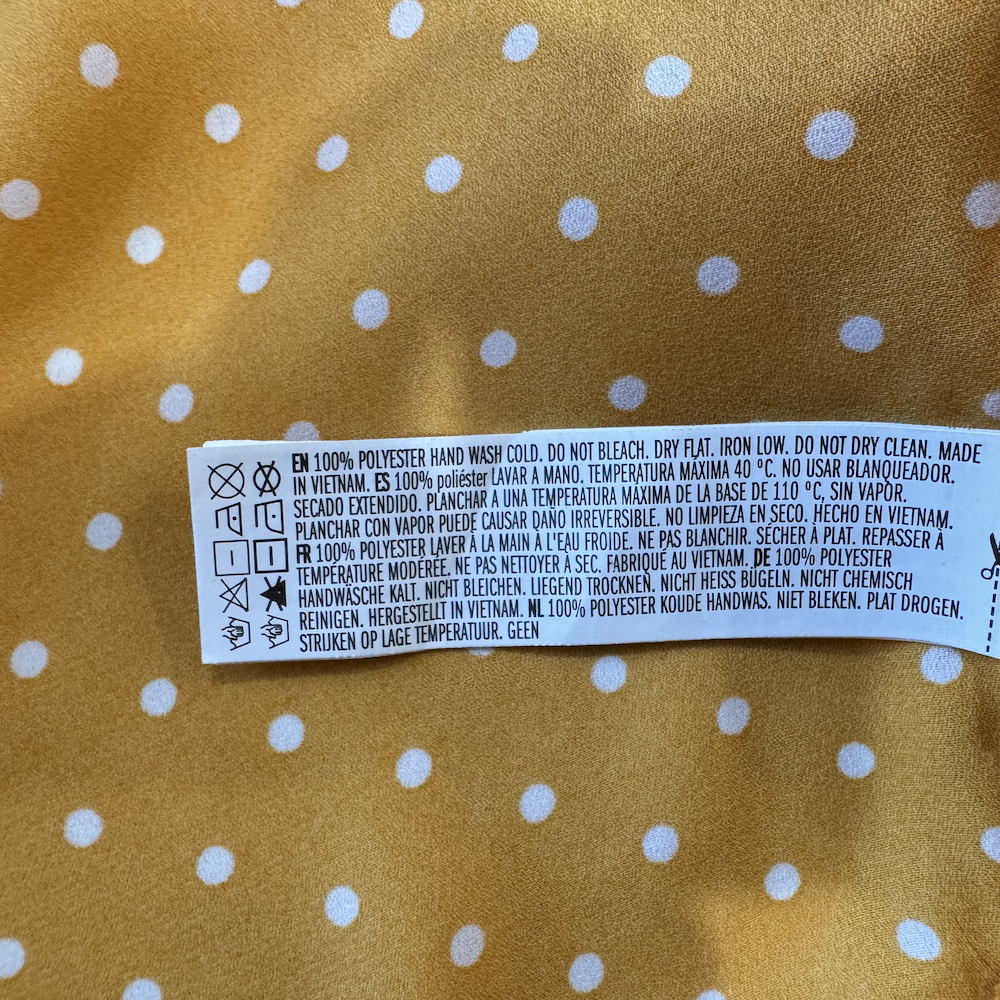 Material tag on Forever 21 women's blouse yellow, size M