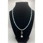 Main View of handmade blue beaded necklace with a silver spiral pendant