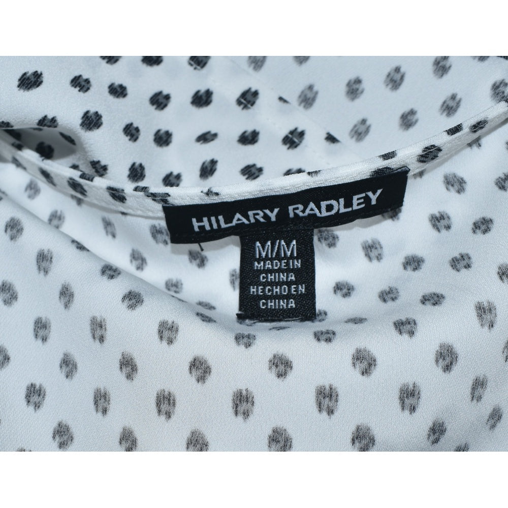 Clothing tag on Hilary Radley blouse white with black polka dots on a white background