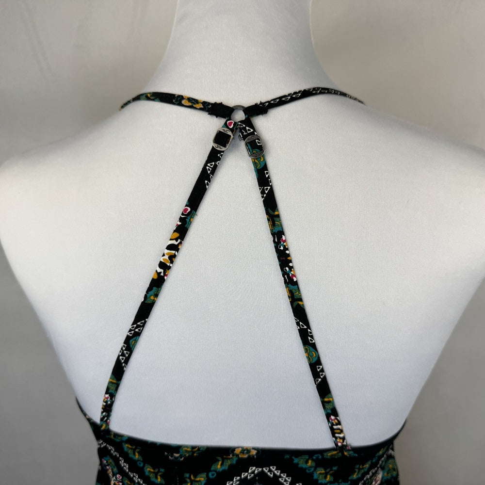 Back detail view on Hollister tank top on a Mannequin wearing a floral dress with thin straps on a plain background