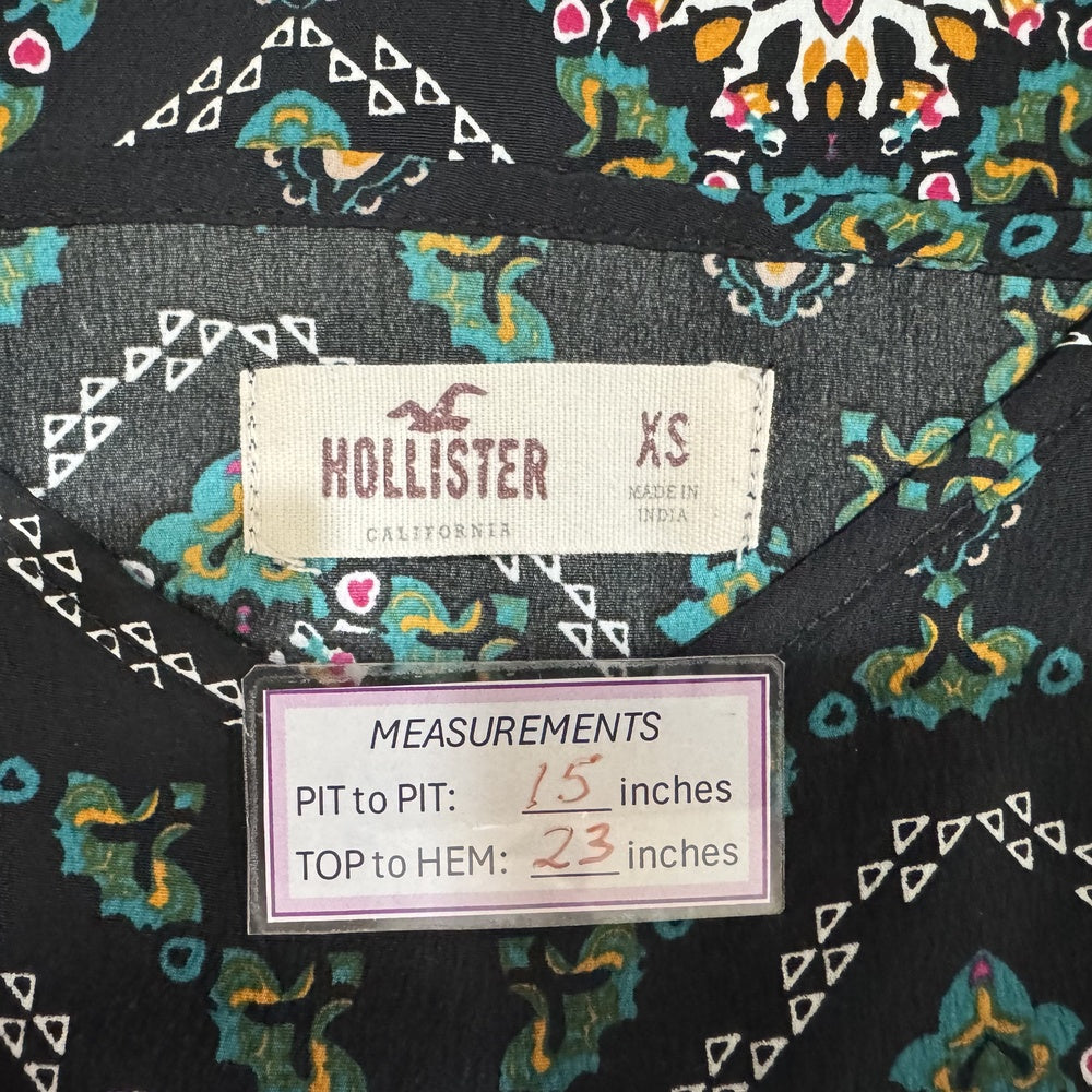 Clothing tag view on a Hollister garment with measurements displayed