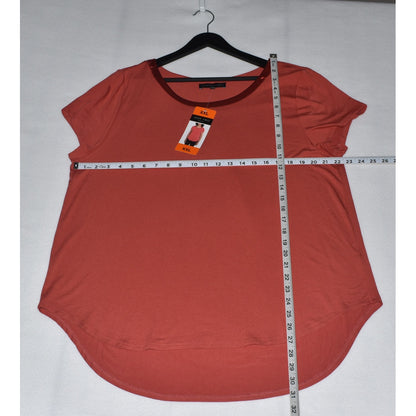 Measurements View on Joan Vass red sleeveless top on a hanger with a measuring tape for size reference against a white background