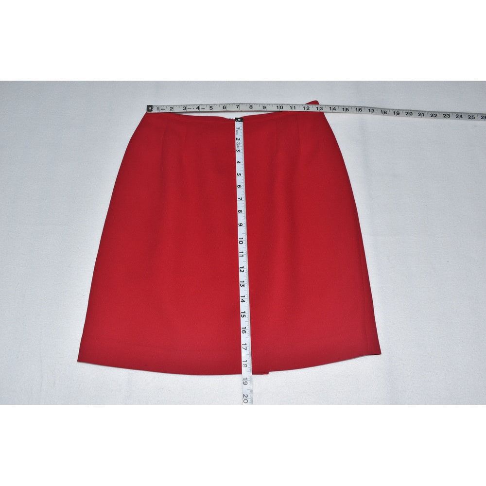 Measurement view on Kasper red skirt with a measuring tape on a white background
