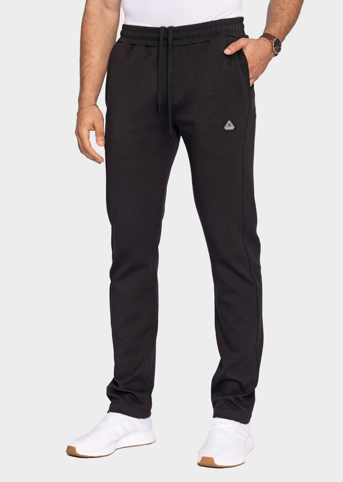 SCR Sportswear men's black classic athleisure tapered sweatpants in tall fit with drawstring waist, modeled front view.