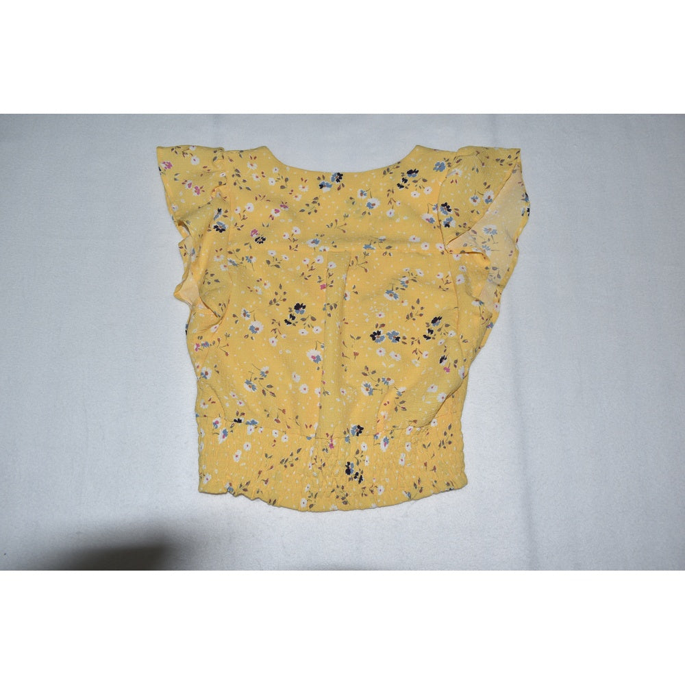 Back view on Monteau crop top yellow floral on a gray background
