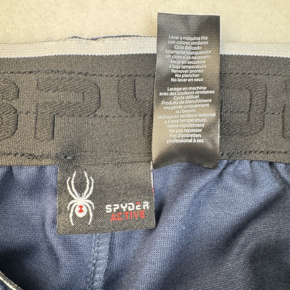 Clothing care tag view on Spyder blue jogger pants, size S
