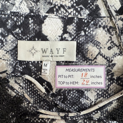 Clothing tag view of patterned fabric with 'WAYF' brand label and measurements