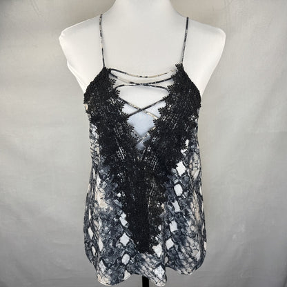 Front view on Wayf camisole black and white patterned lace top on a mannequin against a plain background