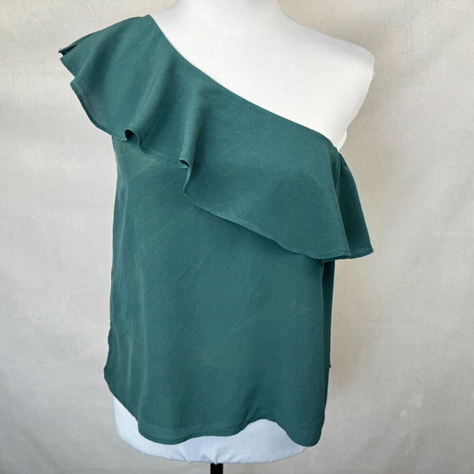 A teal green one-shoulder ruffled blouse displayed on a white mannequin torso against a light gray fabric backdrop.