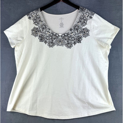 An off-white short-sleeve top with a black floral lace collar, hanging on a black hanger against a dark gray background.