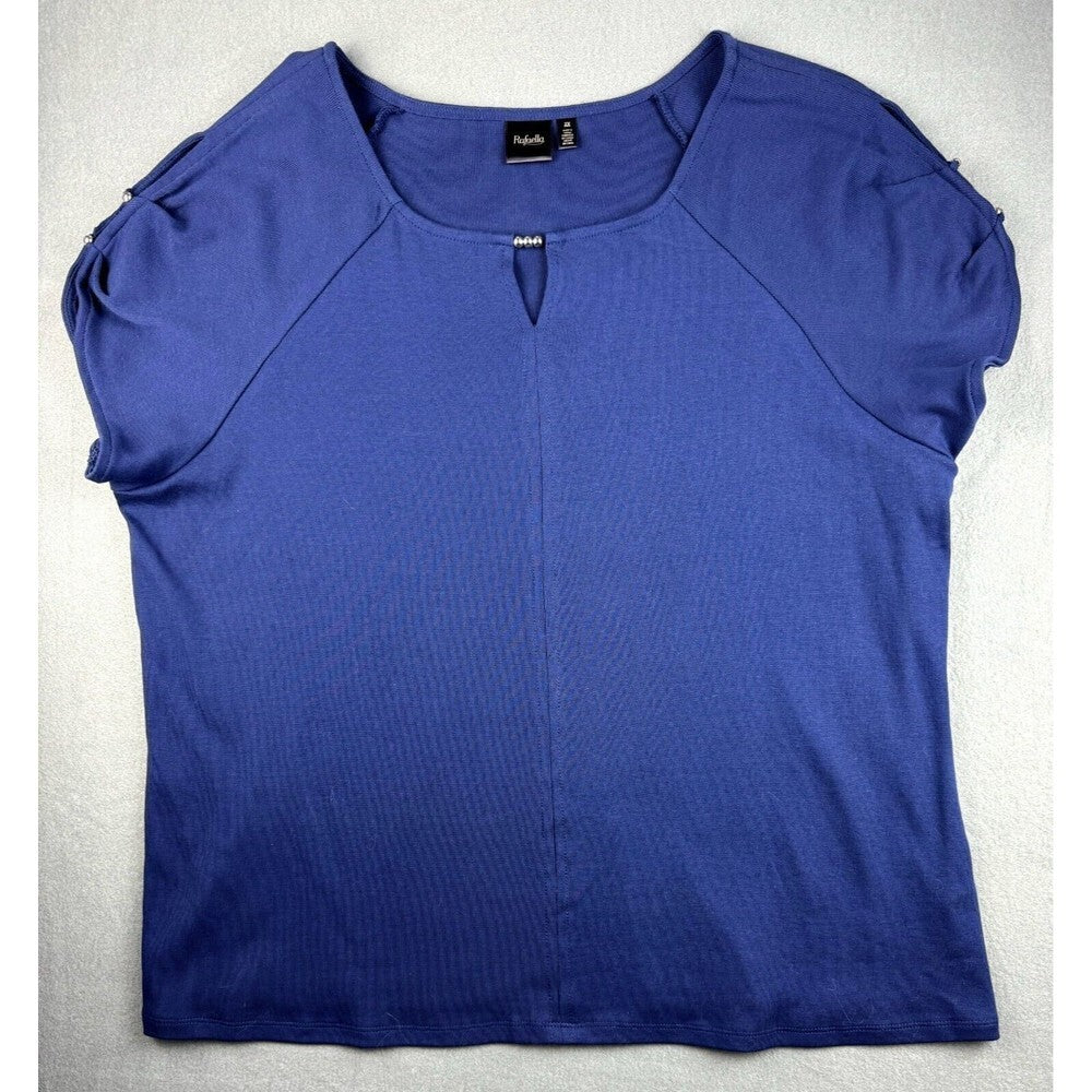 A royal blue short-sleeve knit top with shoulder cutouts and a small keyhole neckline detail, laid flat on a light gray background.