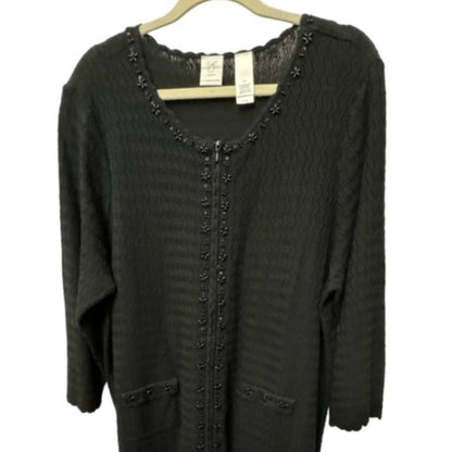 A dark charcoal gray knit cardigan sweater with scalloped edges and decorative bead trim, hanging on a wooden hanger against a white background.