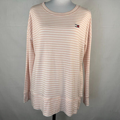 A Tommy Hilfiger long-sleeve tunic top with horizontal peach and white stripes, displayed on a mannequin against a gray background.